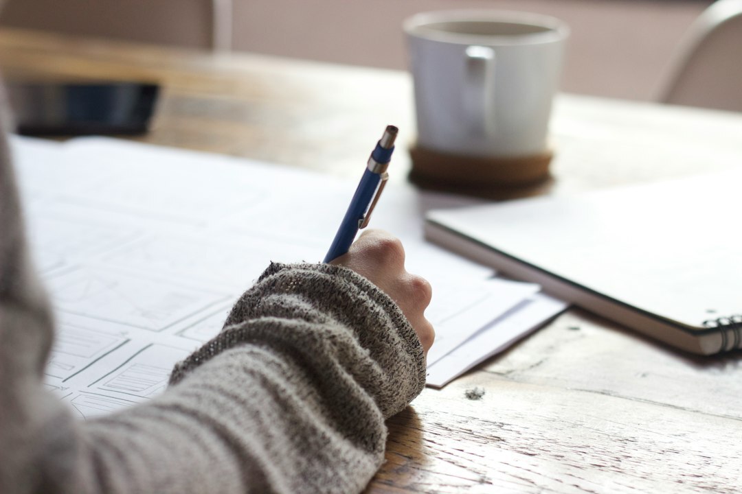 tense writer at desk typing mystery novel